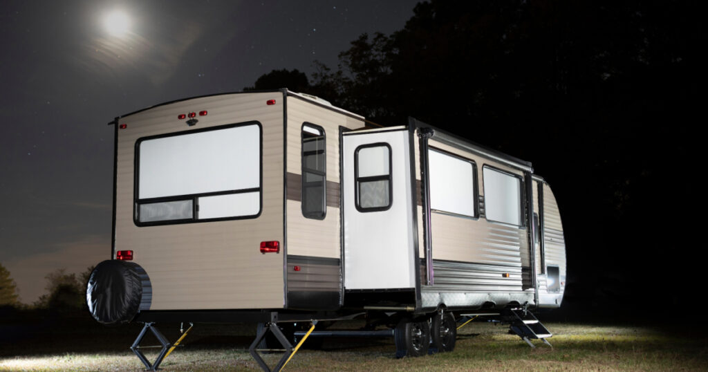 Night-time picture of an RV with slide-out.