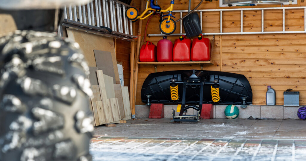 Picture of stored snow plow in garage.