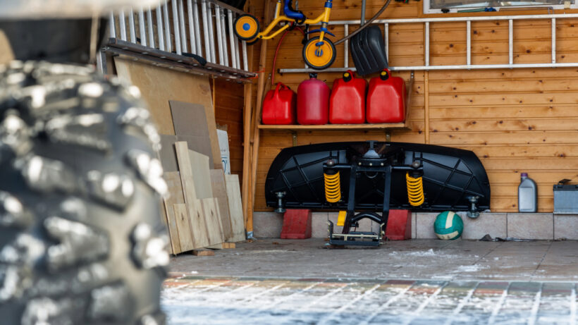 Picture of stored snow plow in garage.